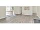 View of living room leading to patio and bedroom areas with modern gray wood flooring at 244 N Race St, Statesville, NC 28677