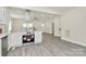 View of bright open-concept area with kitchen, living room and gray wood-look flooring at 244 N Race St, Statesville, NC 28677