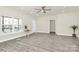 Bright living room featuring large windows, ceiling fan, and modern gray wood flooring at 244 N Race St, Statesville, NC 28677