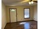 This room features wood-look flooring, a window and a door to the outside at 2601 Bobwhite Cir, Wingate, NC 28174