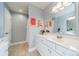 Bright bathroom featuring a white vanity, neutral tile floors, and modern decor at 2953 Craftsman Ln, Charlotte, NC 28204