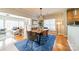 Open-concept dining room with a stylish blue rug, modern light fixture, and natural light streaming in from the windows at 2953 Craftsman Ln, Charlotte, NC 28204