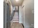 Inviting entryway with a staircase featuring wood and white accents and tile flooring at 2953 Craftsman Ln, Charlotte, NC 28204