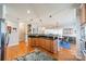 Open kitchen view, granite counters, and stainless appliances flow into the dining area with stylish lighting at 2953 Craftsman Ln, Charlotte, NC 28204