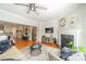 Cozy living room with hardwood floors, fireplace, a ceiling fan and an open floor plan at 2953 Craftsman Ln, Charlotte, NC 28204