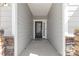 Inviting entryway with a modern front door framed by stone pillars and neutral siding at 2953 Findley Rd, Statesville, NC 28625