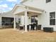 Covered back patio features an outdoor kitchen, seating, and room to relax at 3008 Quinebaug Rd, Fort Mill, SC 29715