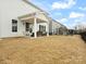 Backyard with covered patio, featuring a swing and plenty of space for activities at 3008 Quinebaug Rd, Fort Mill, SC 29715