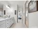Modern bathroom showcasing double sinks, sleek fixtures, and a view into the bedroom and shower at 3008 Quinebaug Rd, Fort Mill, SC 29715