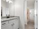 Bathroom featuring a vanity with stone countertop, black fixtures, and doorway view to the next room at 3008 Quinebaug Rd, Fort Mill, SC 29715