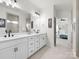 Modern bathroom showcasing double sinks, sleek fixtures, and a view into the bedroom and shower at 3008 Quinebaug Rd, Fort Mill, SC 29715
