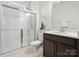 Modern bathroom featuring a glass-enclosed shower, sleek vanity with storage, and tiled flooring at 3008 Quinebaug Rd, Fort Mill, SC 29715