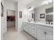 Bright bathroom featuring double sinks, a large mirror, and access to the closet at 3008 Quinebaug Rd, Fort Mill, SC 29715