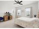 Bright bedroom with ceiling fan, two windows with natural light, and neutral colored walls and floors at 3008 Quinebaug Rd, Fort Mill, SC 29715