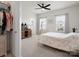 Bright bedroom with ceiling fan, two windows with natural light, and neutral colored walls and floors at 3008 Quinebaug Rd, Fort Mill, SC 29715
