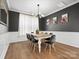 Elegant dining room with dark walls, modern lighting, seating for eight, and stylish decor at 3008 Quinebaug Rd, Fort Mill, SC 29715