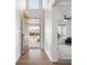 Bright foyer featuring hardwood floors, wainscoting, and an open view into a living area with neutral decor at 3008 Quinebaug Rd, Fort Mill, SC 29715