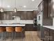 Modern kitchen featuring brown cabinets, stainless steel appliances, and a spacious island with bar stool seating at 3008 Quinebaug Rd, Fort Mill, SC 29715