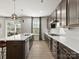 Stylish kitchen boasts a large island with pendant lighting and backyard access, seamlessly blending indoor and outdoor living at 3008 Quinebaug Rd, Fort Mill, SC 29715