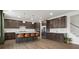 Modern kitchen with dark cabinetry, stainless steel appliances, a large island, and hardwood floors at 3008 Quinebaug Rd, Fort Mill, SC 29715