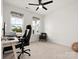 Cozy office with two large windows, neutral carpet, a ceiling fan, and comfortable office furniture at 3008 Quinebaug Rd, Fort Mill, SC 29715