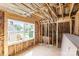 Attic under construction with insulation, visible framing, and a window that overlooks the surrounding neighborhood at 341 Bynum Ave, Rock Hill, SC 29732