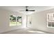 Sunlit bedroom with neutral walls, ceiling fan, and large windows offering a view of the backyard at 341 Bynum Ave, Rock Hill, SC 29732