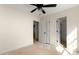 Bright bedroom featuring a ceiling fan, white walls, and multiple doors, awaiting your personal touch at 341 Bynum Ave, Rock Hill, SC 29732