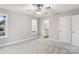 Neutral bedroom with a ceiling fan, carpet, a window, and a view of the bathroom at 341 Bynum Ave, Rock Hill, SC 29732