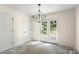 Bright dining room with backyard view through glass doors and decorative chandelier at 341 Bynum Ave, Rock Hill, SC 29732