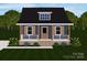 Charming home with blue siding, front porch, shutters, and a well-manicured lawn at 341 Bynum Ave, Rock Hill, SC 29732