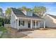 Charming home featuring a welcoming front porch, dark shutters, and a well-manicured lawn at 341 Bynum Ave, Rock Hill, SC 29732