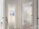 Bright hallway featuring a modern chandelier, natural wood railing, and white doors at 341 Bynum Ave, Rock Hill, SC 29732