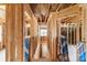 Hallway under construction with exposed studs, insulation, and drywall; view leads to a door and window at the end at 341 Bynum Ave, Rock Hill, SC 29732