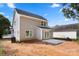 Rear view of a gray two-story home with white trim and a concrete patio, awaiting your personal touch at 341 Bynum Ave, Rock Hill, SC 29732