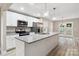 Modern kitchen featuring granite countertops, stainless steel appliances, and bright lighting over the island at 341 Bynum Ave, Rock Hill, SC 29732
