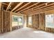 Unfinished living room with exposed beams, studs, and windows showing construction progress at 341 Bynum Ave, Rock Hill, SC 29732