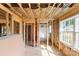 Unfinished living room revealing frame, insulation, and views into bathroom and from the window, highlighting build progress at 341 Bynum Ave, Rock Hill, SC 29732
