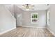 Bright living room featuring hardwood floors, a modern ceiling fan, and a view of the front yard through large windows at 341 Bynum Ave, Rock Hill, SC 29732