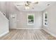 Bright living room featuring hardwood floors, a modern ceiling fan, and a view of the front yard through large windows at 341 Bynum Ave, Rock Hill, SC 29732