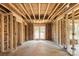 Unfinished living room with exposed studs, insulation, and double doors showing construction progress at 341 Bynum Ave, Rock Hill, SC 29732