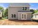Rear exterior of a light-gray two-story home featuring a double glass door and large windows to maximize natural light at 341 Bynum Ave, Rock Hill, SC 29732