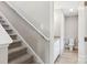 Stairway with carpeted steps and an adjacent powder room featuring a toilet and white cabinets at 341 Bynum Ave, Rock Hill, SC 29732