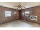 A bedroom featuring wood paneling, a ceiling fan, and an air conditioning unit at 3467 Clearview Ln, Maiden, NC 28650