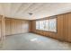 A bedroom with a large window for lots of light, carpet, and wood paneling at 3467 Clearview Ln, Maiden, NC 28650