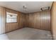 A simple bedroom with wood paneling and a window allowing natural light at 3467 Clearview Ln, Maiden, NC 28650