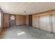A bedroom with carpet, wood paneling, closet space, and a window for natural light at 3467 Clearview Ln, Maiden, NC 28650
