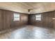 An empty bedroom with wood floors, wood paneling and two windows for natural light at 3467 Clearview Ln, Maiden, NC 28650