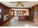 Open concept kitchen with wood paneling, tile floor, ceiling fan and wood cabinets at 3467 Clearview Ln, Maiden, NC 28650