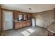 A vintage kitchen with wood cabinets, patterned wallpaper, and an integrated sink at 3467 Clearview Ln, Maiden, NC 28650